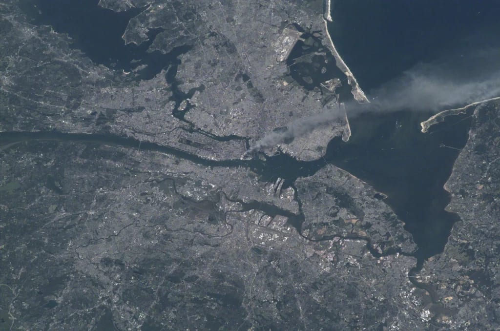 Courtesy: National Archives Foundation | Visible from space, a smoke plume rises from the Manhattan area.