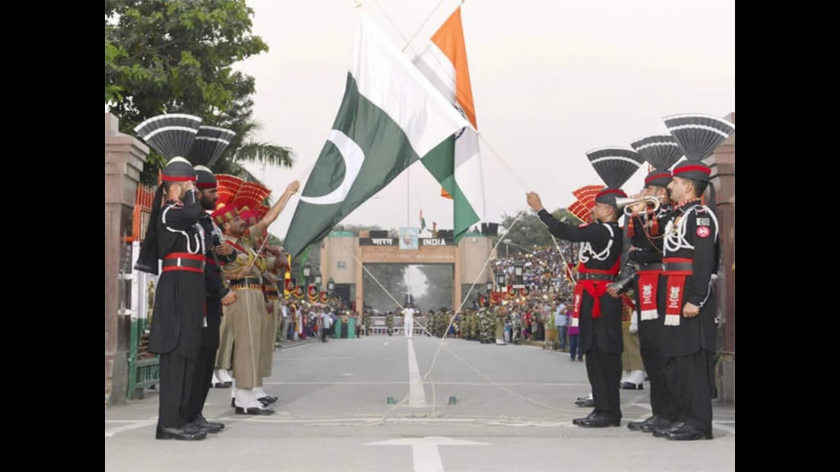 Indian and Pakistani border guards lower their flags during the Wagah–Attari border ceremony
